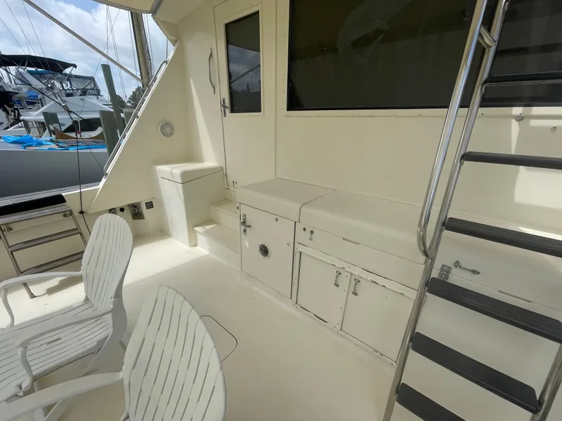 Slide: The Image of 1988 Hatteras 55 Convertible yacht deck with seating and storage. - 9