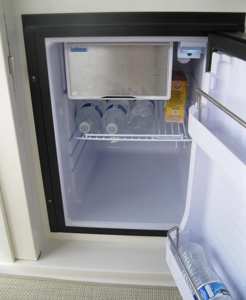 Slide: The Image of Mini fridge on 2008 Sea Ray 330 Sundancer yacht, stocked with water bottles and juice. - 12