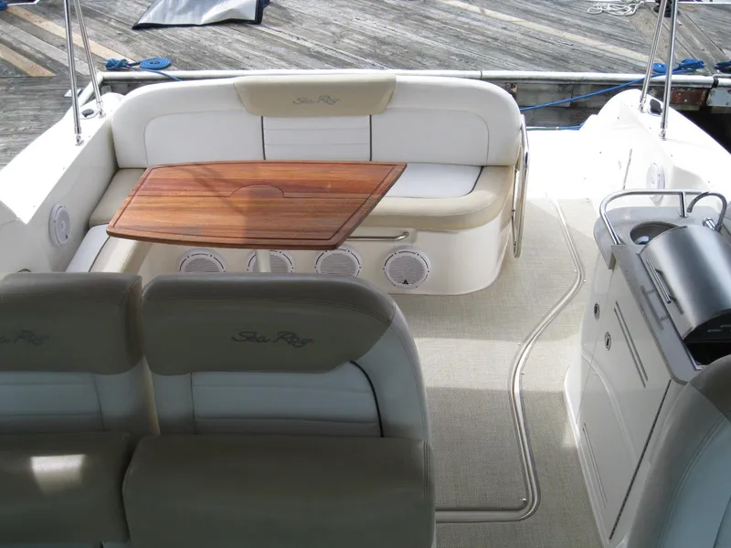 Slide: The Image of 2008 Sea Ray 330 Sundancer interior with seating and wooden table. - 16