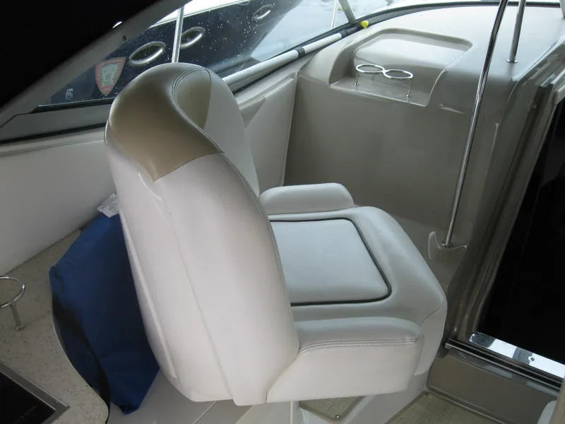 Slide: The Image of Captain's seat on 2008 Sea Ray 330 Sundancer boat, featuring white upholstery. - 17