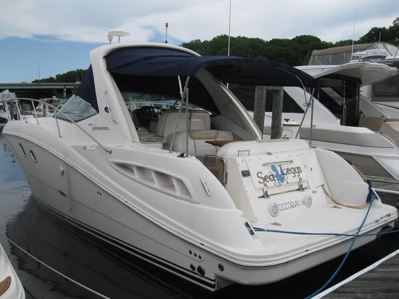 Slide: The Image of 2008 Sea Ray 330 Sundancer yacht docked at marina with blue canopy. - 2