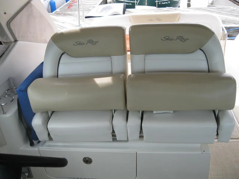 Slide: The Image of 2008 Sea Ray 330 Sundancer boat seats, beige and white, with Sea Ray logo. - 23