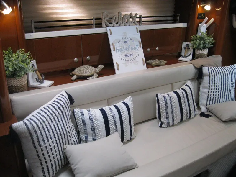 Slide: The Image of Luxurious interior of 2008 Sea Ray 330 Sundancer with striped pillows and decor. - 31