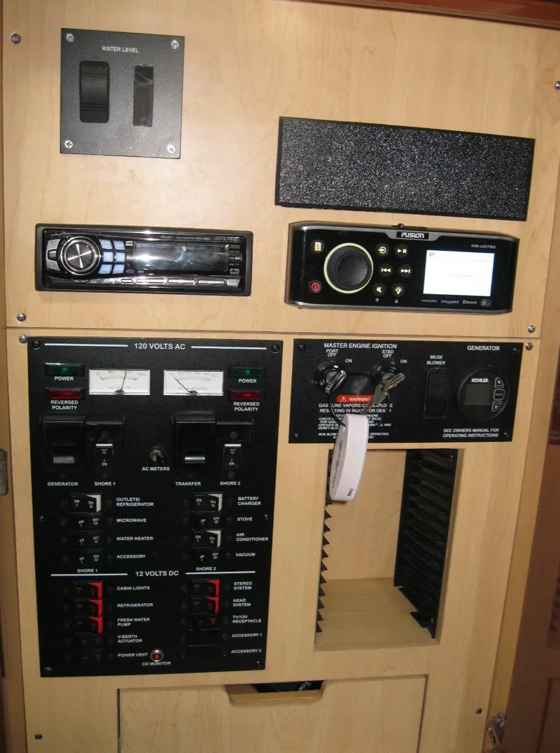 Slide: The Image of Control panel of a 2008 Sea Ray 330 Sundancer boat with various switches and displays. - 48