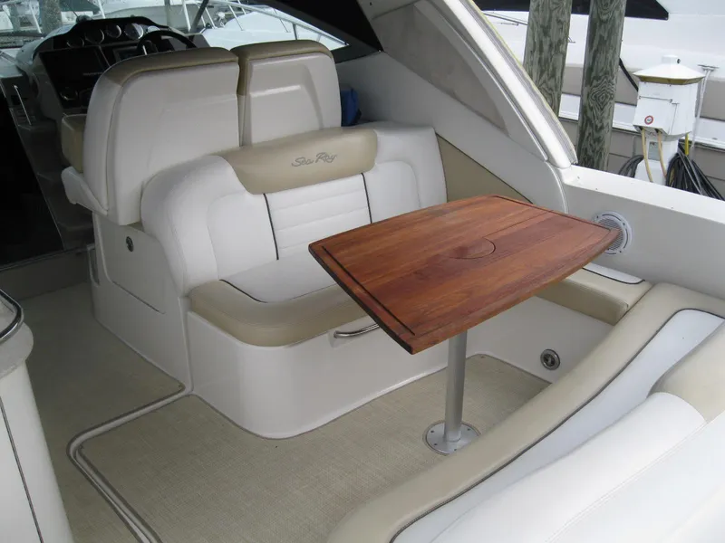 Slide: The Image of 2008 Sea Ray 330 Sundancer interior with white seating and wooden table. - 5