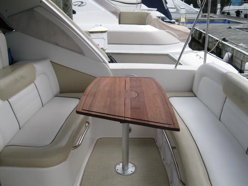 Slide: The Image of 2008 Sea Ray 330 Sundancer interior with wooden table and cushioned seating. - 6