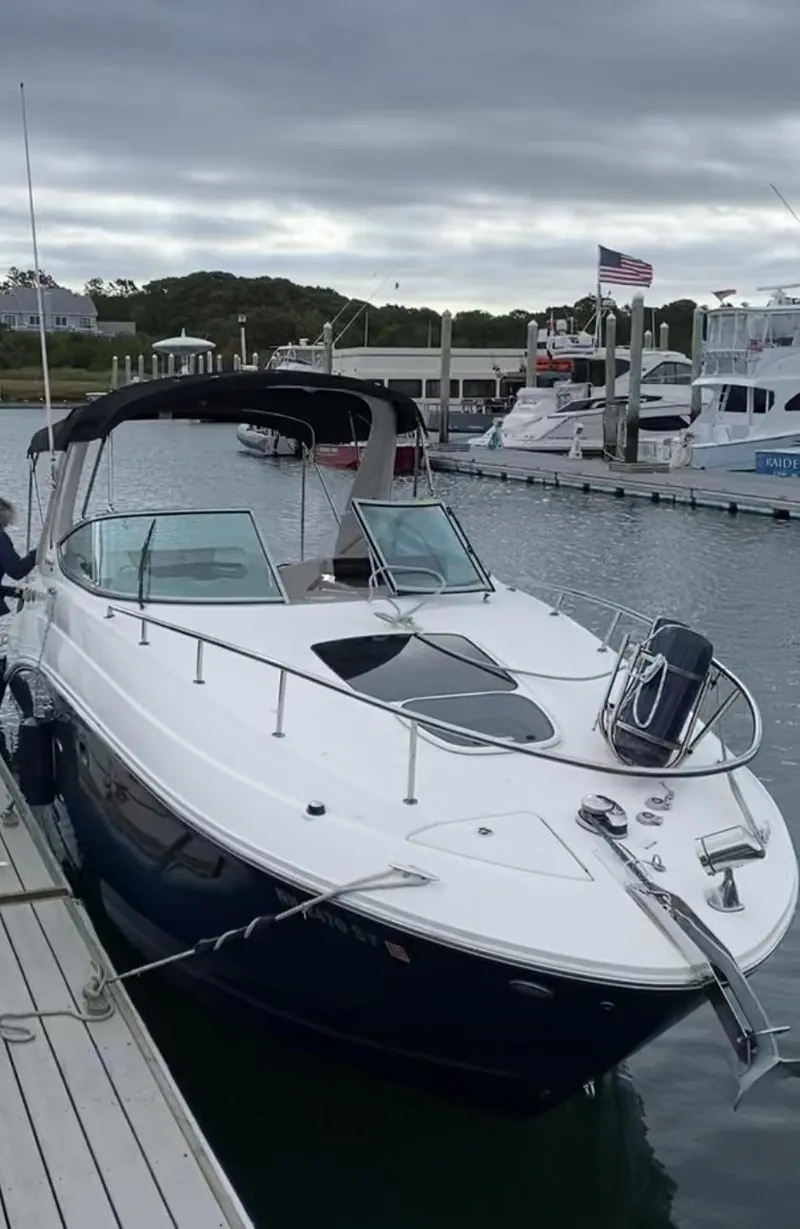 Slide: The Image of 2015 Sea Ray 280 Sundancer docked in a marina under cloudy skies. - 10