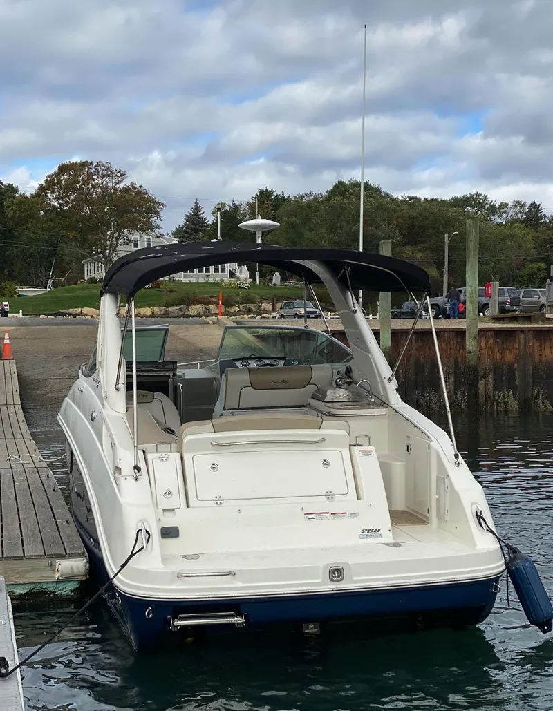 Slide: The Image of 2015 Sea Ray 280 Sundancer docked at a marina under cloudy skies. - 11