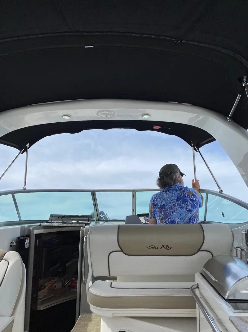 Slide: The Image of 2015 Sea Ray 280 Sundancer interior with person enjoying ocean view. - 12