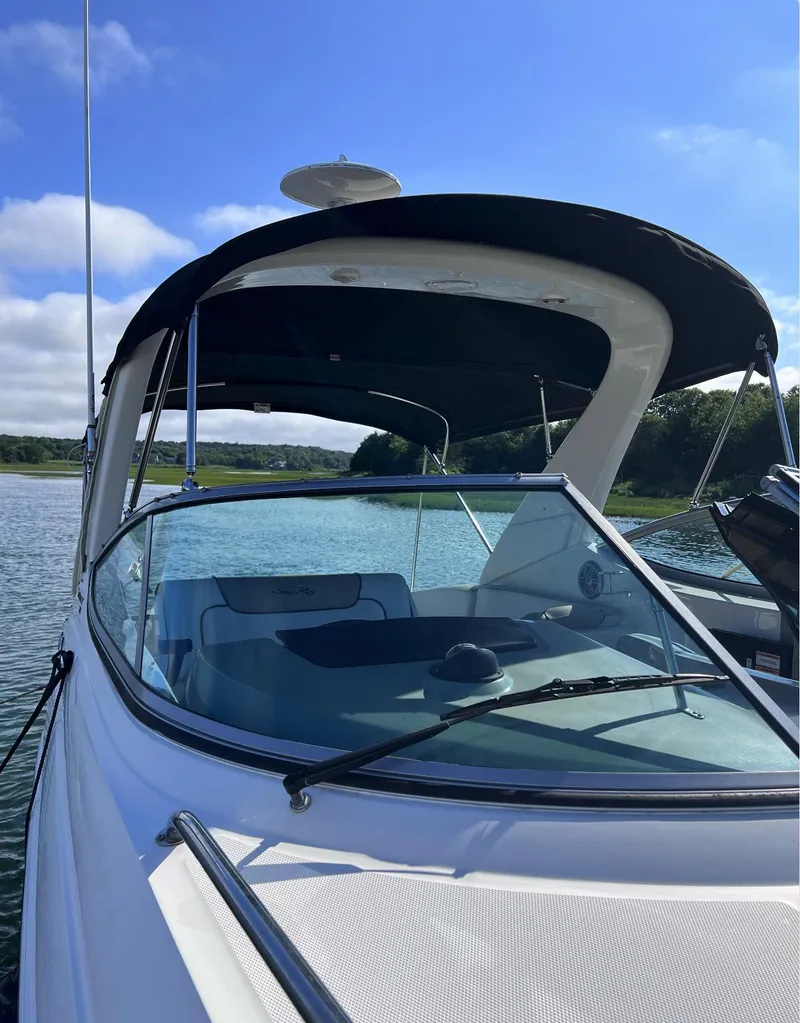 Slide: The Image of 2015 Sea Ray 280 Sundancer boat on calm water under clear blue sky. - 13