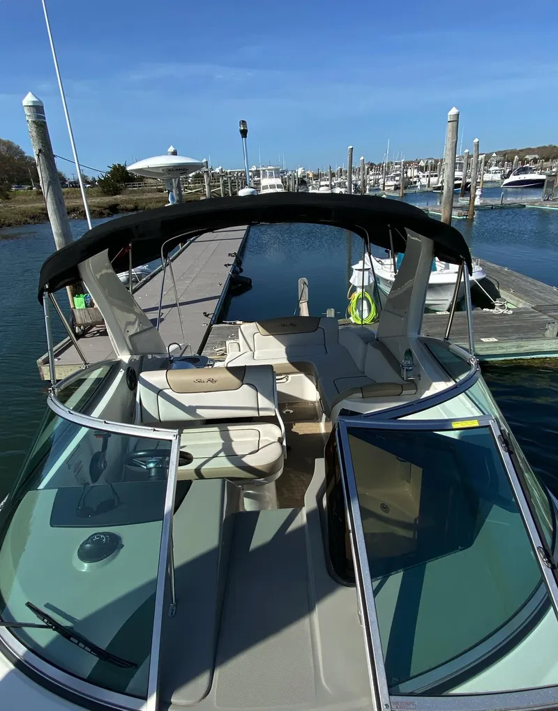 Slide: The Image of 2015 Sea Ray 280 Sundancer docked at marina, featuring spacious deck and sleek design. - 16