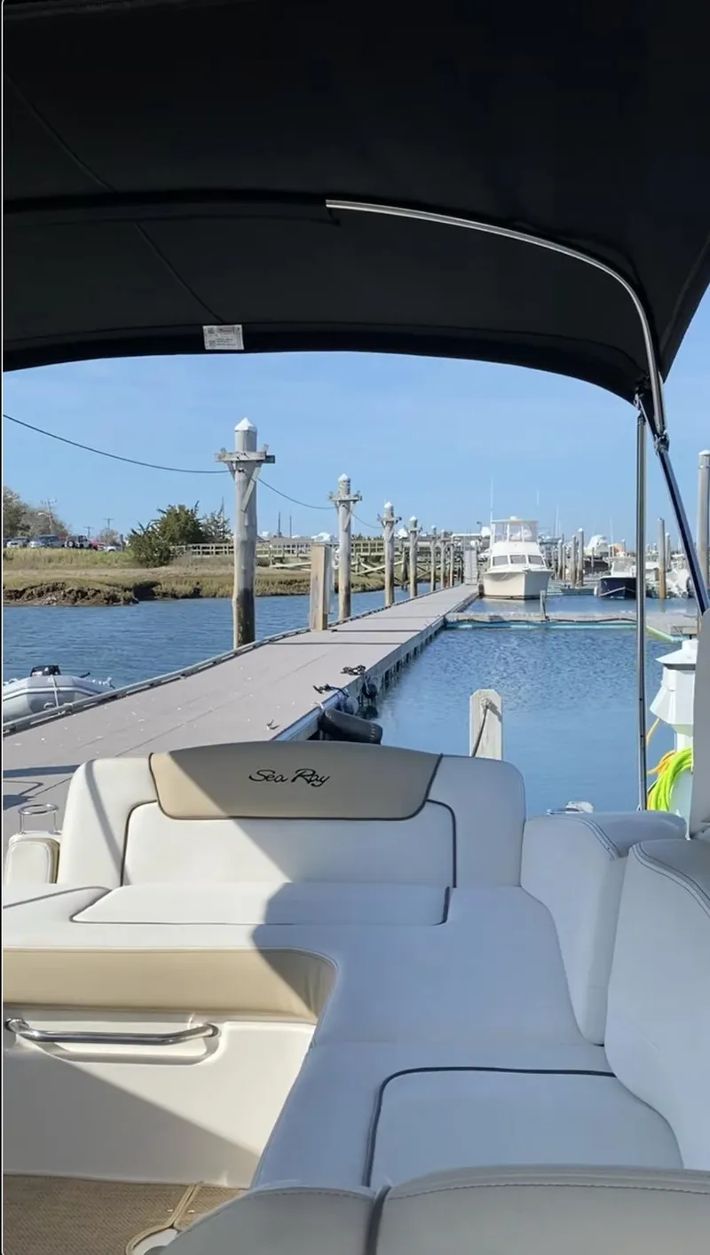 Slide: The Image of 2015 Sea Ray 280 Sundancer docked at marina, sunny day, calm waters. - 18
