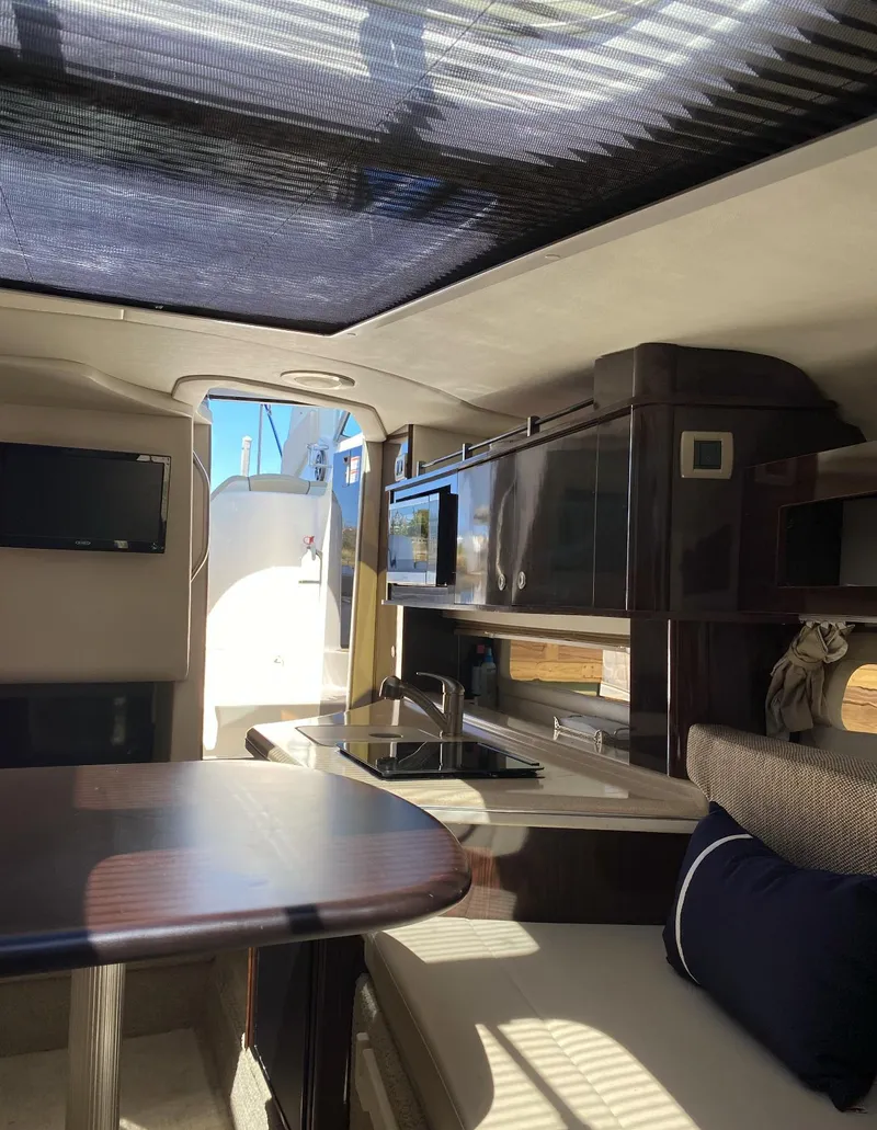 Slide: The Image of Interior of 2015 Sea Ray 280 Sundancer yacht with modern amenities and seating. - 24