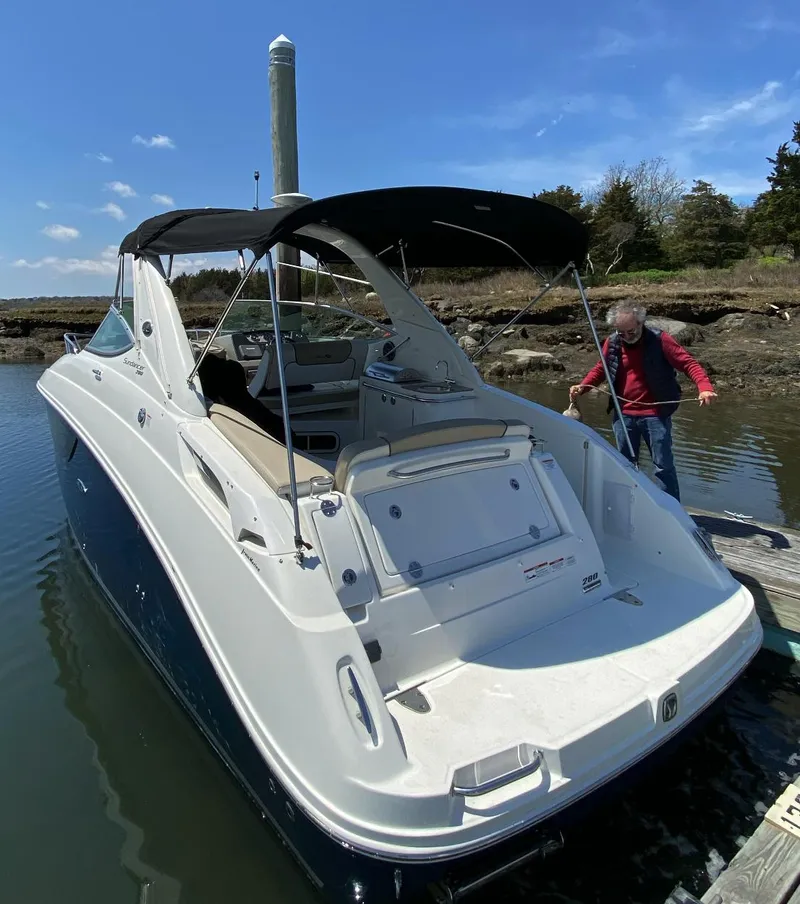 Slide: The Image of 2015 Sea Ray 280 Sundancer docked, featuring sleek design and spacious deck. - 3