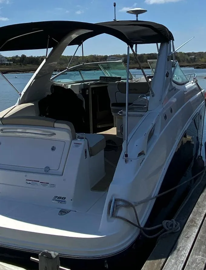 Slide: The Image of 2015 Sea Ray 280 Sundancer docked, featuring sleek design and spacious cockpit. - 5