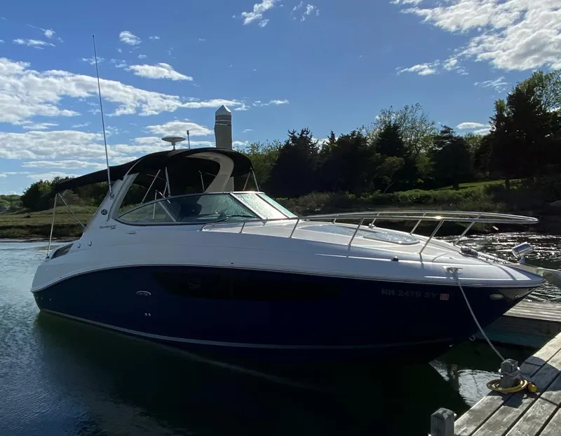 Slide: The Image of 2015 Sea Ray 280 Sundancer boat docked on a sunny day with blue sky. - 6