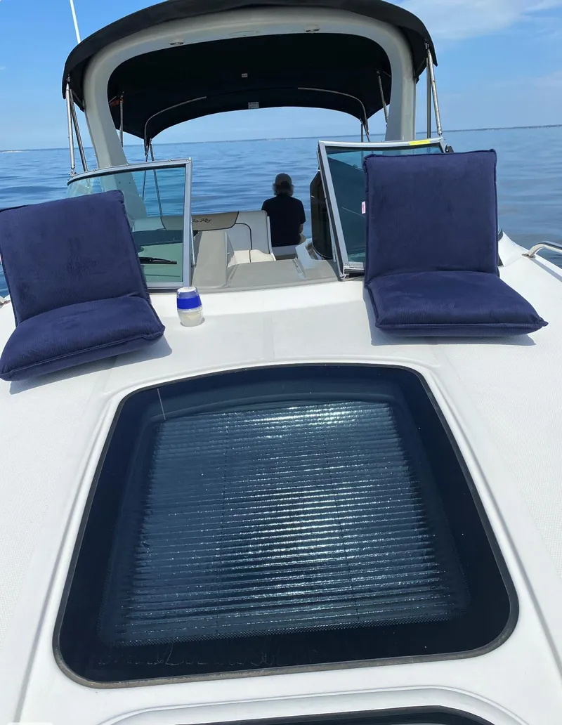 Slide: The Image of 2015 Sea Ray 280 Sundancer boat with sunbathing cushions on deck, open sea view. - 8