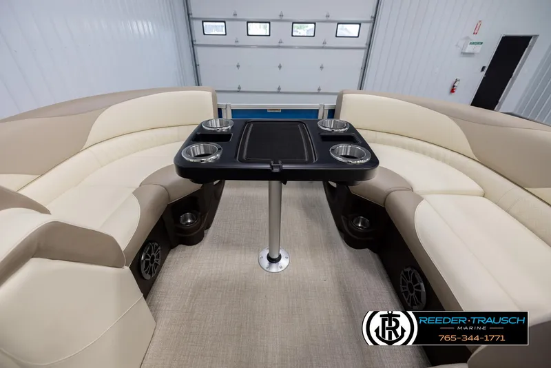 Slide: The Image of Luxurious seating area on 2025 Avalon LSZ QLS pontoon boat with table and cup holders. - 19