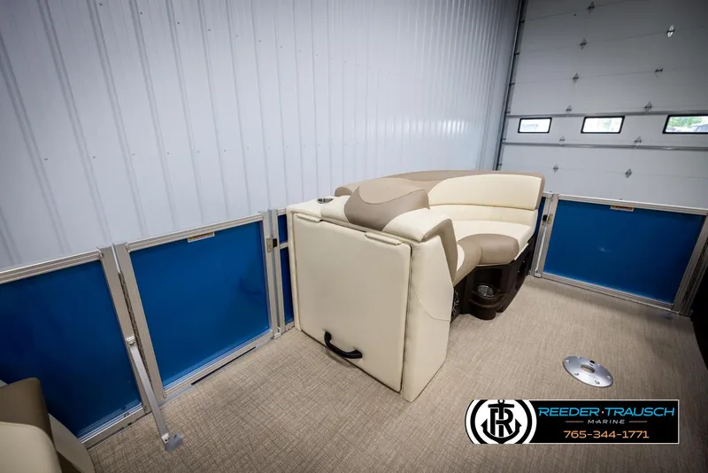 Slide: The Image of 2025 Avalon LSZ QLS pontoon boat interior with beige seating in a showroom. - 25