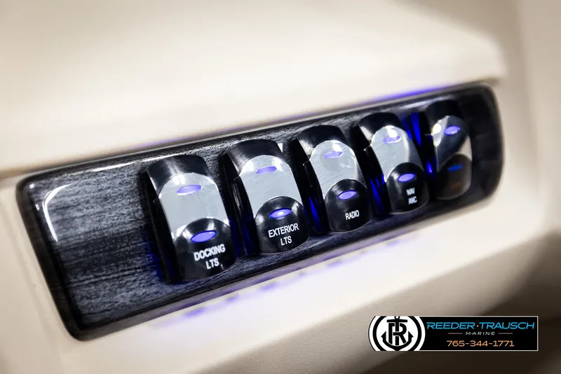 Slide: The Image of Control panel of 2025 Avalon LSZ QLS with illuminated switches for docking, exterior lights, and radio. - 37