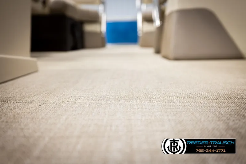 Slide: The Image of Carpeted interior of 2025 Avalon LSZ QLS boat, featuring Reeder-Trausch Marine branding. - 46