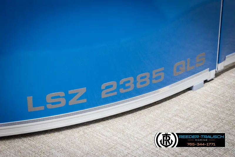 Slide: The Image of 2025 Avalon LSZ QLS boat with blue exterior and Reeder-Trausch Marine logo. - 49