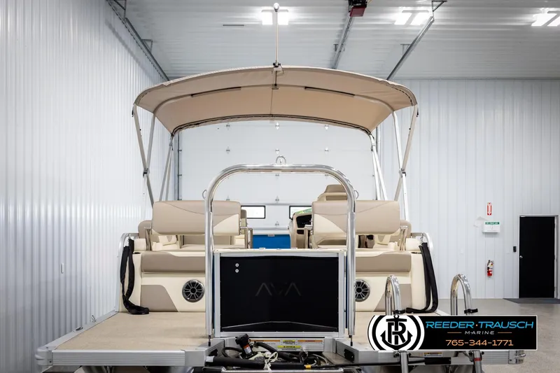 Slide: The Image of 2025 Avalon LSZ QLS pontoon boat in a showroom with beige seating and canopy. - 7