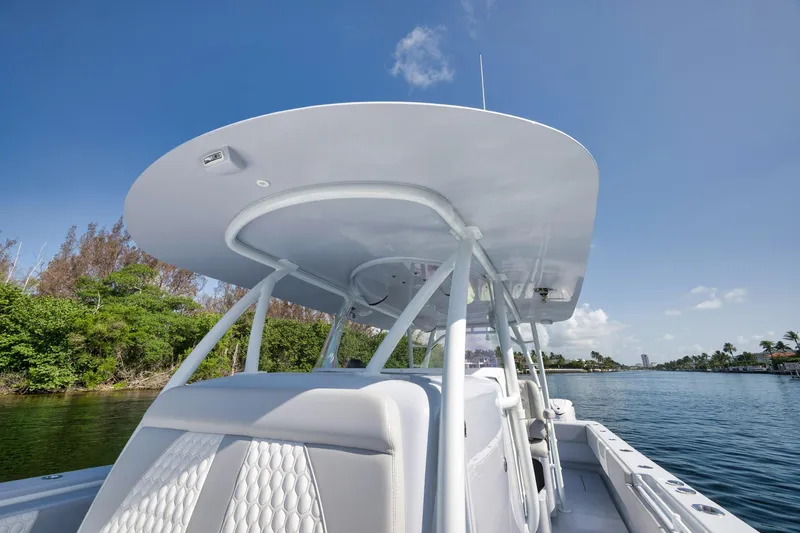 Slide: The Image of 2025 Contender 44 ST boat on calm water, featuring sleek design and modern canopy. - 13