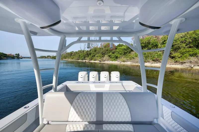 Slide: The Image of 2025 Contender 44 ST boat interior with quad engines, cruising on a scenic waterway. - 26