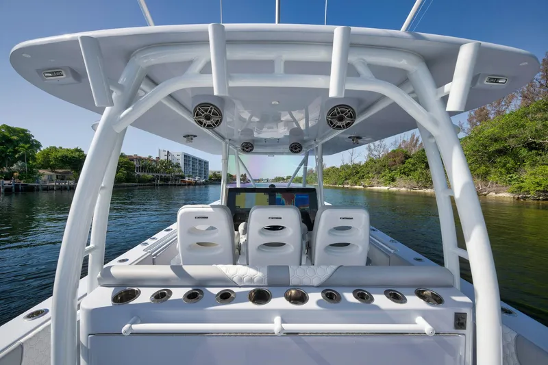 Slide: The Image of 2025 Contender 44 ST boat interior with seating and rod holders on a sunny day. - 29