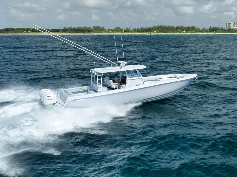 Slide: The Image of 2025 Contender 44 ST boat cruising on open water, showcasing sleek design and powerful engines. - 3