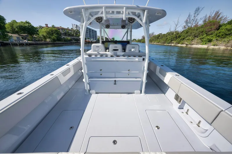 Slide: The Image of 2025 Contender 44 ST boat interior, spacious deck, sleek design, calm water backdrop. - 31