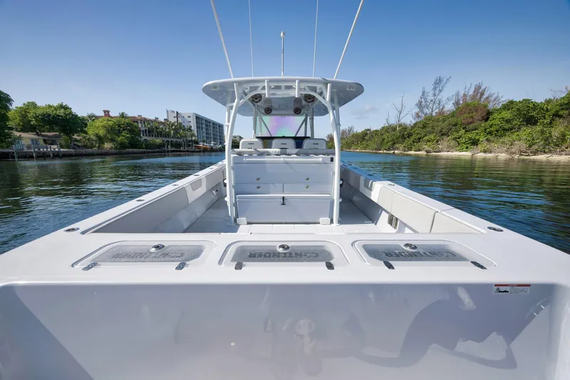 Slide: The Image of 2025 Contender 44 ST boat on calm water, showcasing spacious deck and sleek design. - 42
