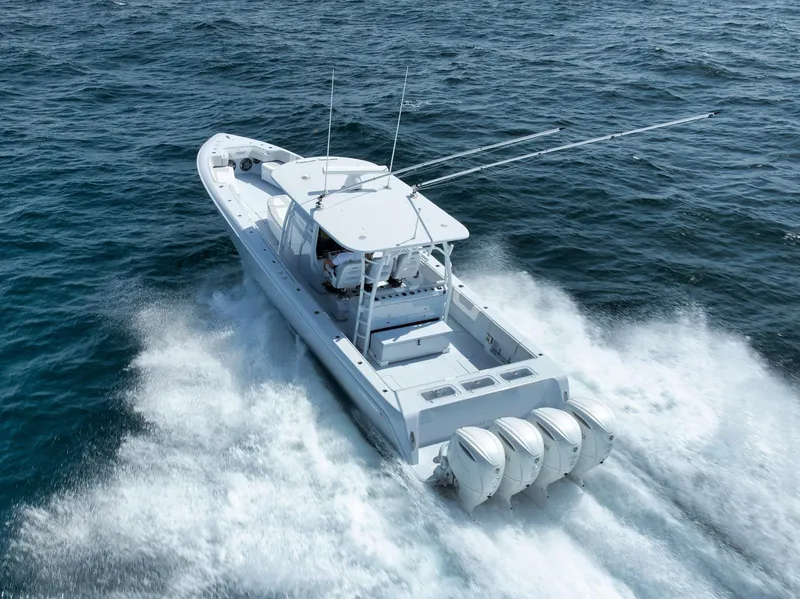 Slide: The Image of 2025 Contender 44 ST boat cruising on open water with triple engines. - 43