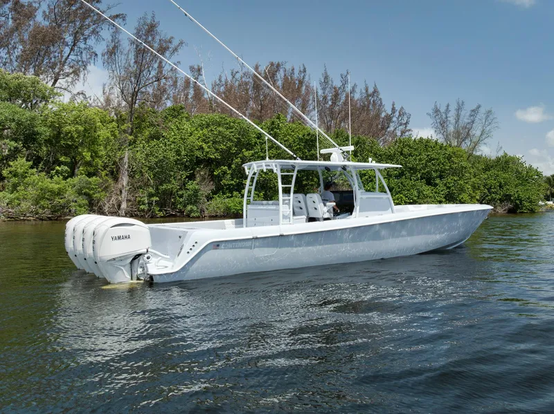 Slide: The Image of 2025 Contender 44 ST boat on calm water, featuring Yamaha engines. - 47