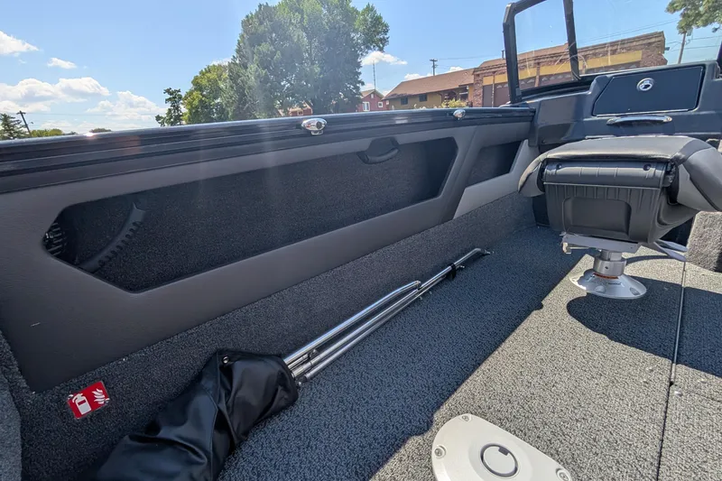 Slide: The Image of 2026 Lund 1875 Crossover XS boat interior with seating and storage compartments. - 16