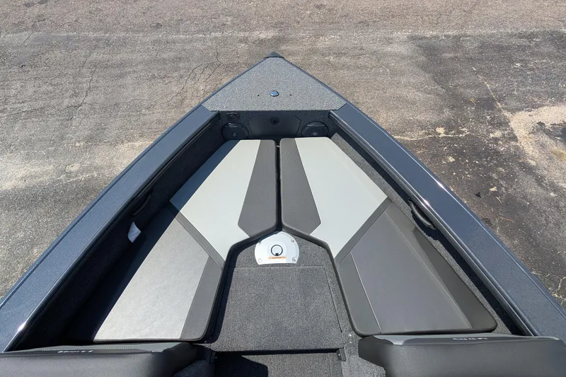 Slide: The Image of 2026 Lund 1875 Crossover XS boat interior, featuring sleek seating and storage compartments. - 7