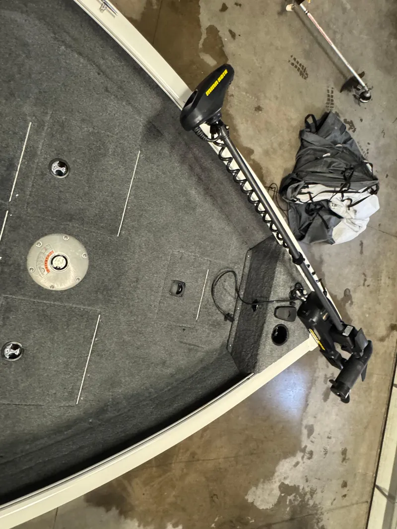 Slide: The Image of 2018 Tracker Pro Guide V-16 WT boat interior with trolling motor and carpeted deck. - 10