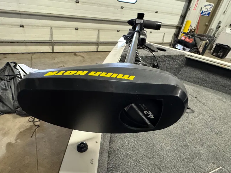 Slide: The Image of 2018 Tracker Pro Guide V-16 WT with Minn Kota trolling motor in a garage setting. - 11