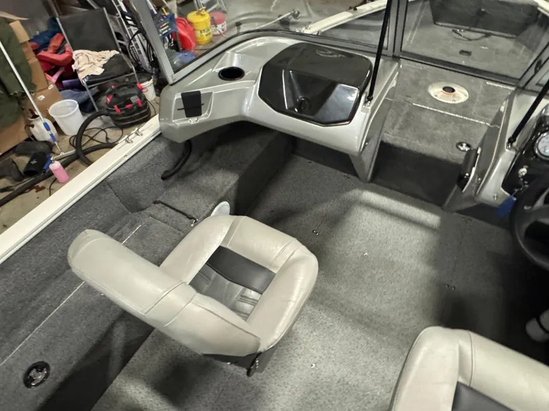 Slide: The Image of 2018 Tracker Pro Guide V-16 WT boat interior with gray seating and console. - 6