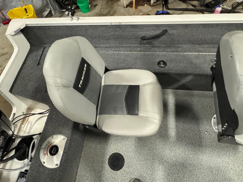Slide: The Image of 2018 Tracker Pro Guide V-16 WT boat interior with gray seating and carpeted flooring. - 7