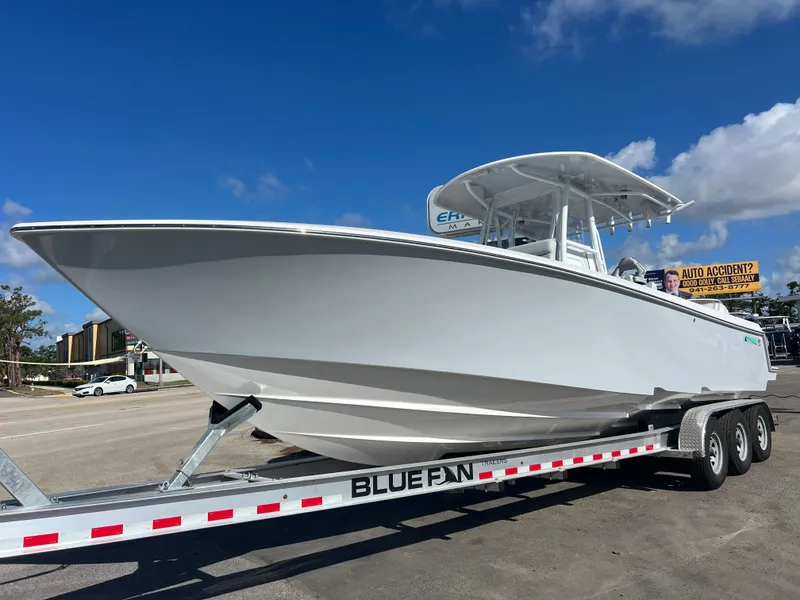 The Image of 2025 Contender 32 ST boat on trailer under clear blue sky. - 0