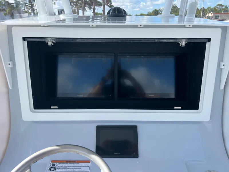 Slide: The Image of Dashboard of 2025 Contender 32 ST boat with dual screens and steering wheel. - 10