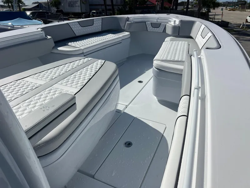 Slide: The Image of 2025 Contender 32 ST boat interior with cushioned seating and sleek design. - 11