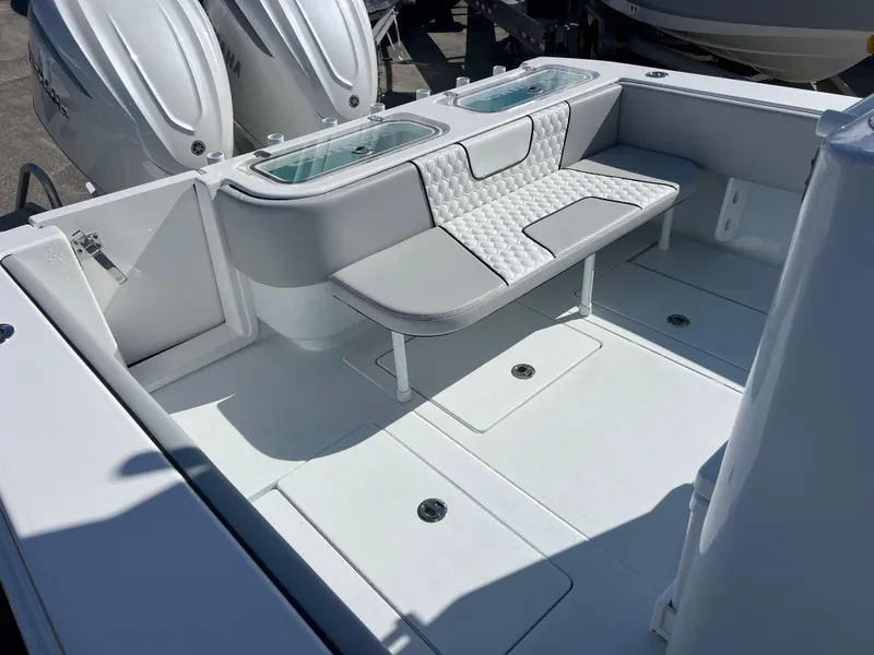 Slide: The Image of 2025 Contender 32 ST boat interior with cushioned seating and dual outboard engines. - 17