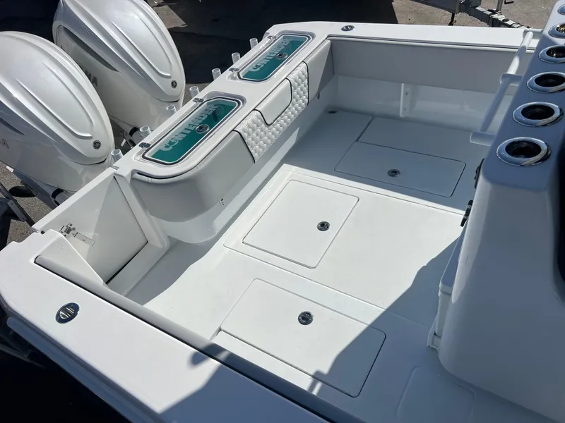Slide: The Image of 2025 Contender 32 ST boat deck with dual engines and storage compartments. - 18