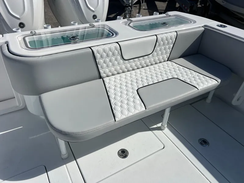 Slide: The Image of 2025 Contender 32 ST boat interior with cushioned seating and storage compartments. - 20