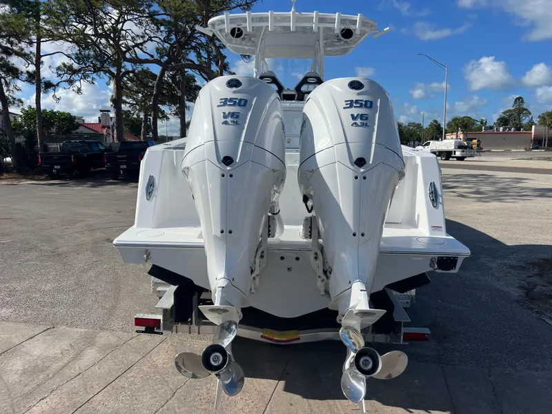Slide: The Image of 2025 Contender 32 ST boat with twin 350 V6 engines, parked outdoors. - 5