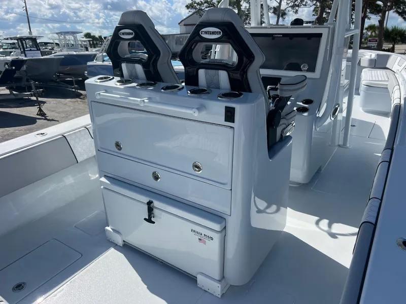 Slide: The Image of 2025 Contender 32 ST boat interior with dual seats and storage compartments. - 8