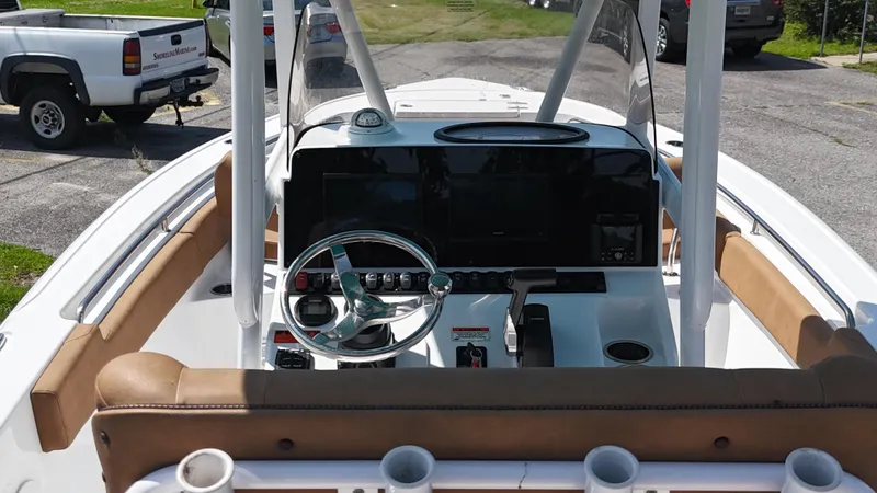 Slide: The Image of 2022 Sea Hunt 229 ULTRA boat dashboard with steering wheel and controls. - 10